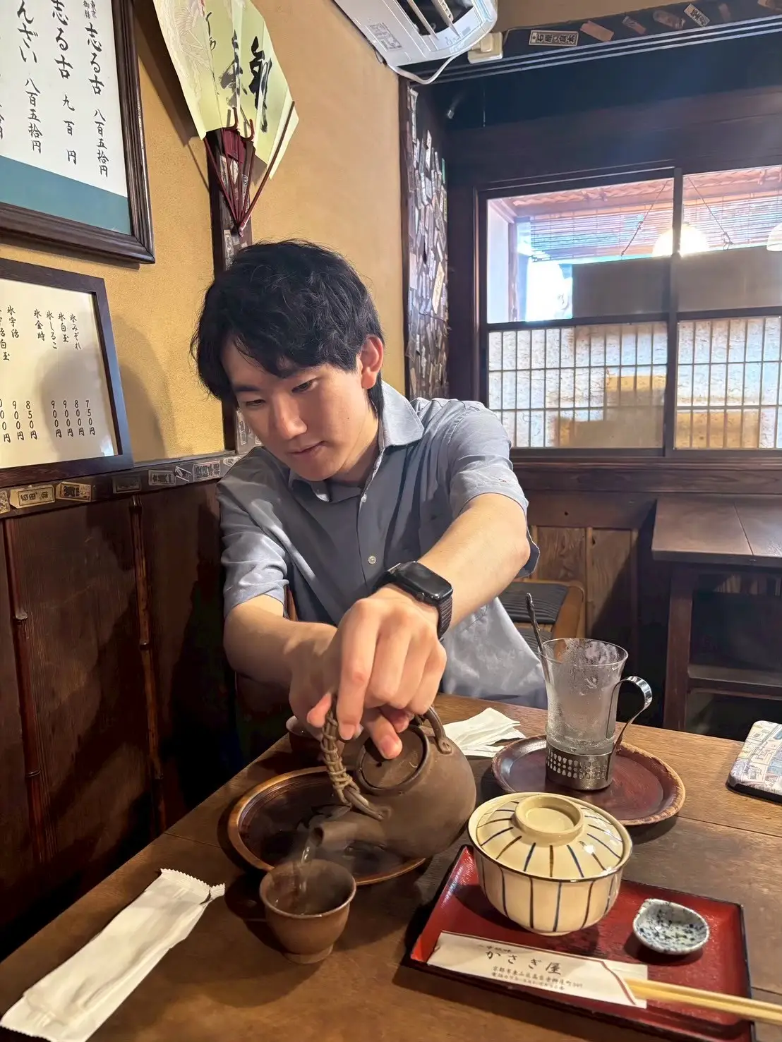 Takuma pouring Japanese green tea at a traditional Kyoto restaurant