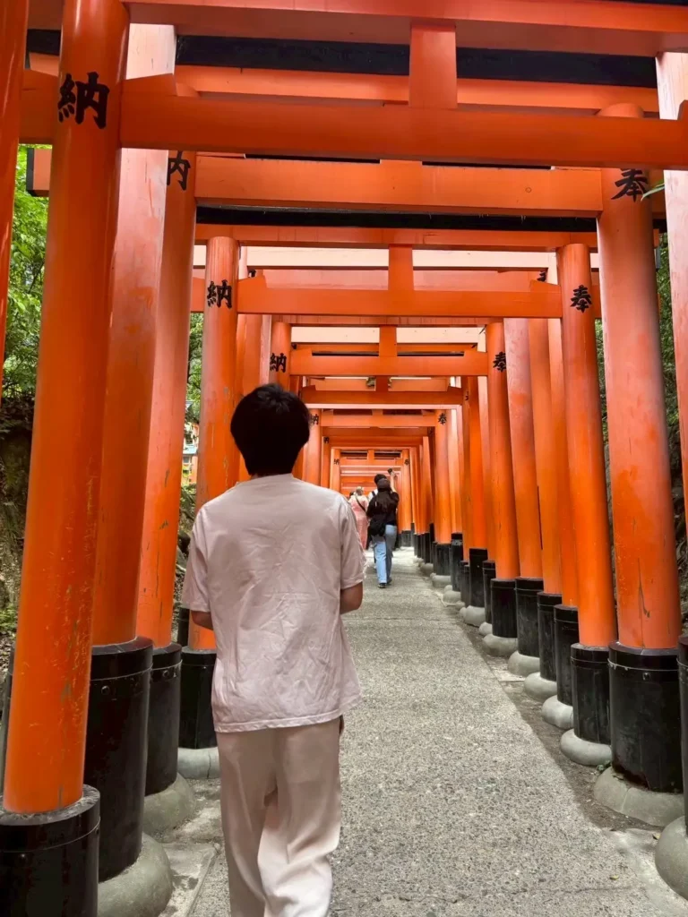 Takuma walking through Fushimi Inari torii gates in Kyoto Japan