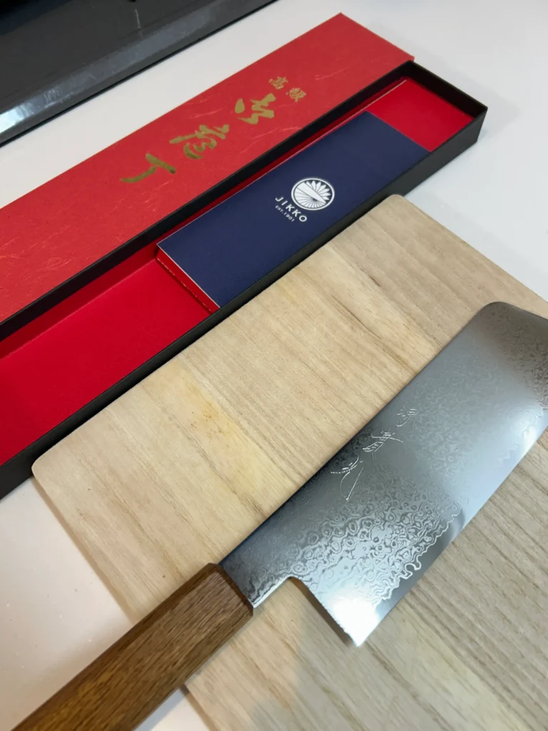 JIKKO Nakiri knife unboxed on wooden cutting board