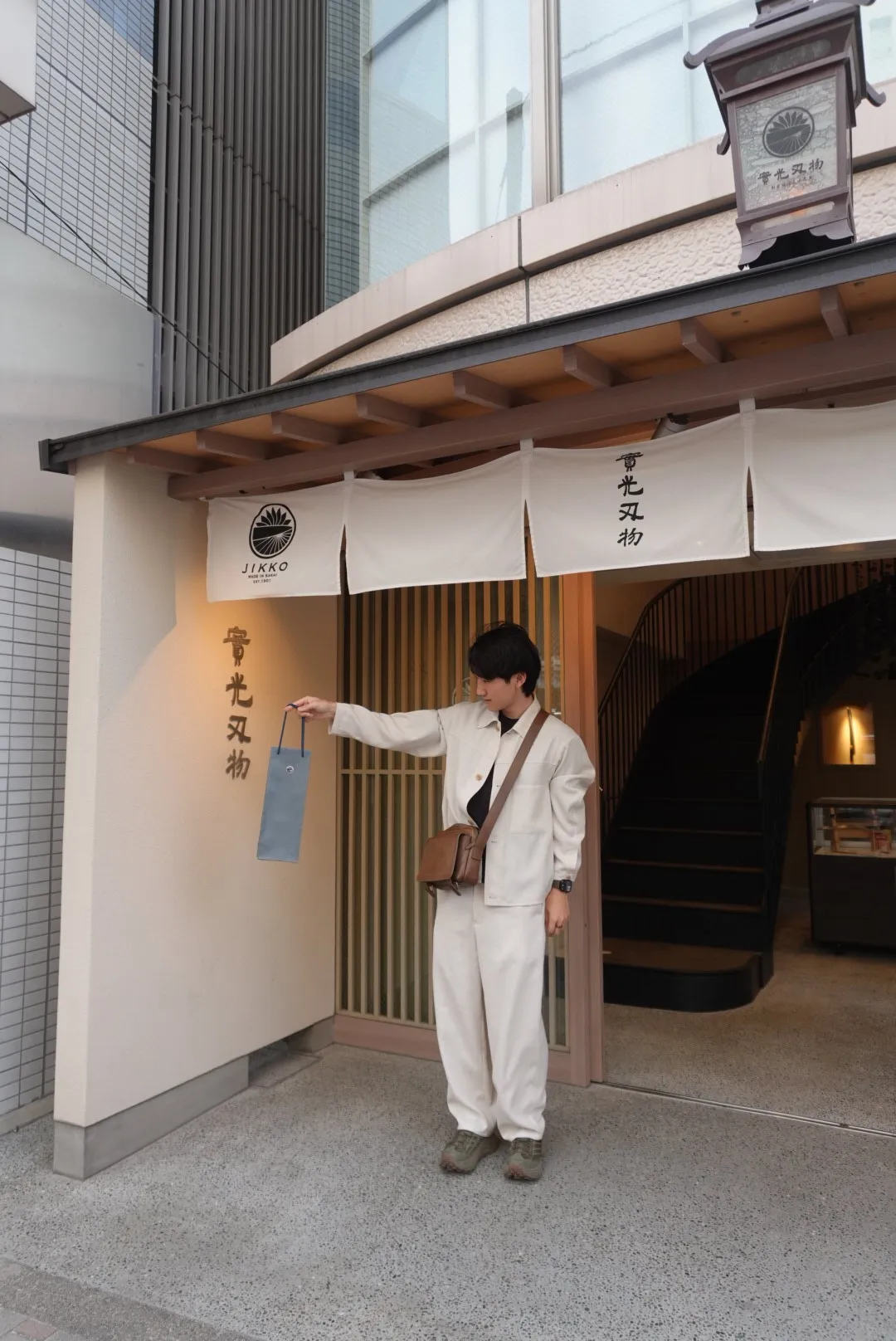 Author at JIKKO knife store in Kappabashi Tokyo holding petty knife purchase